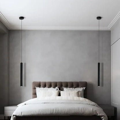 Two sleek black DecorBites™ contemporary nordic led pendant lights hang symmetrically above a bed