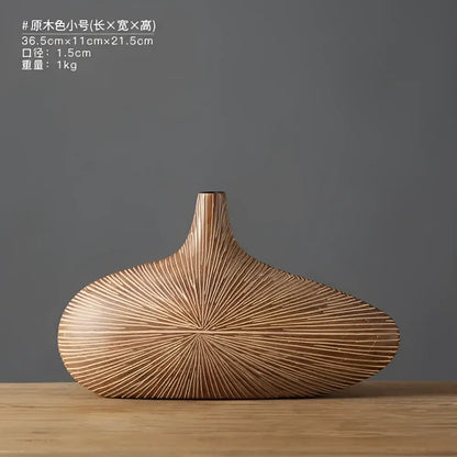 A sleek light brown contemporary resin vase with smooth elongated body and linear grooves for flower arrangements