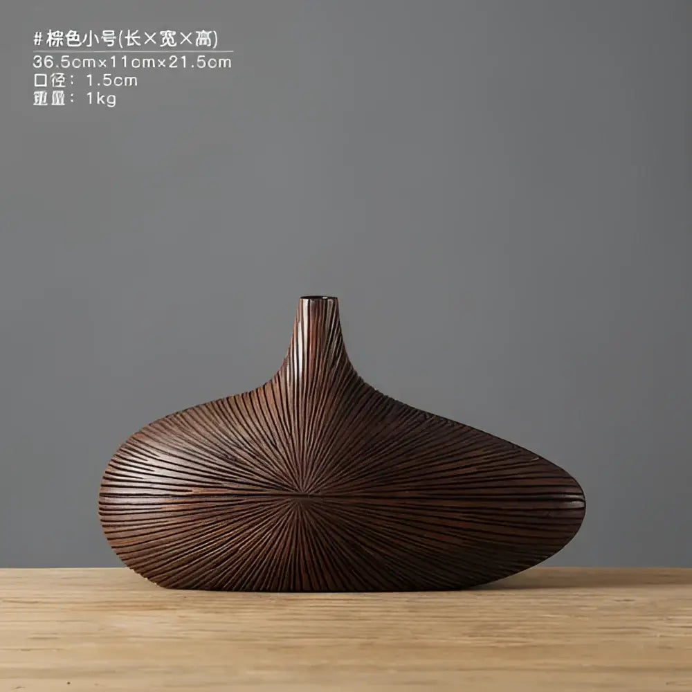 A sleek dark brown contemporary resin vase with smooth elongated body and radiating linear grooves for flower arrangements