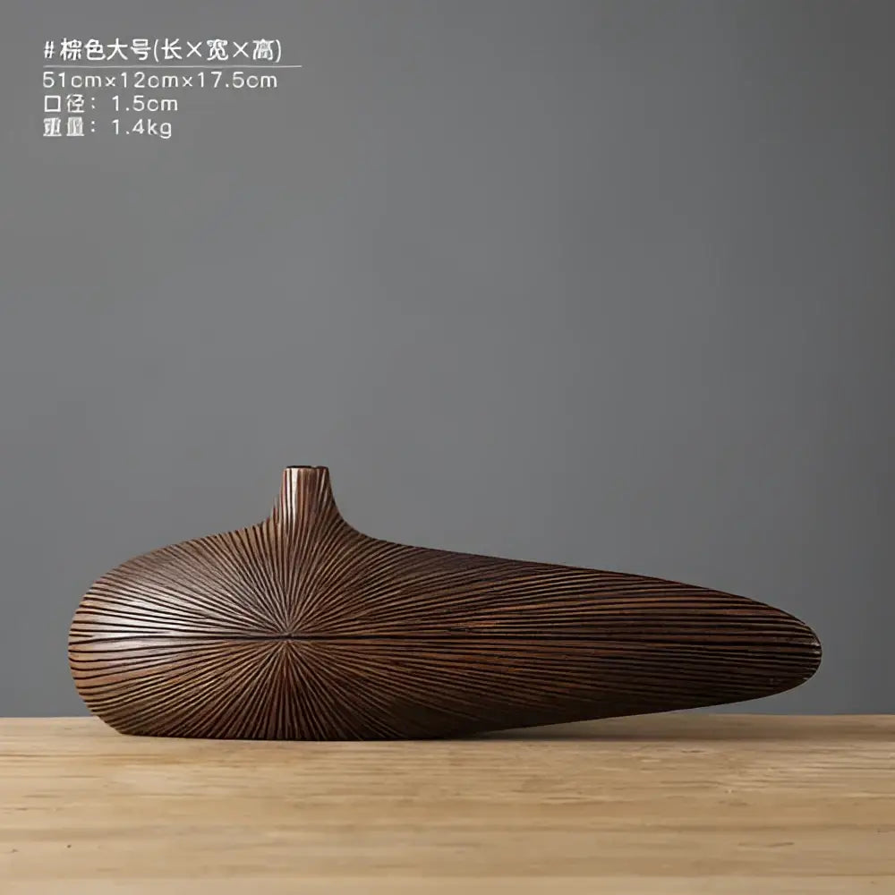 A sleek dark brown contemporary resin vase with smooth elongated body and radiating grooves for flower arrangements