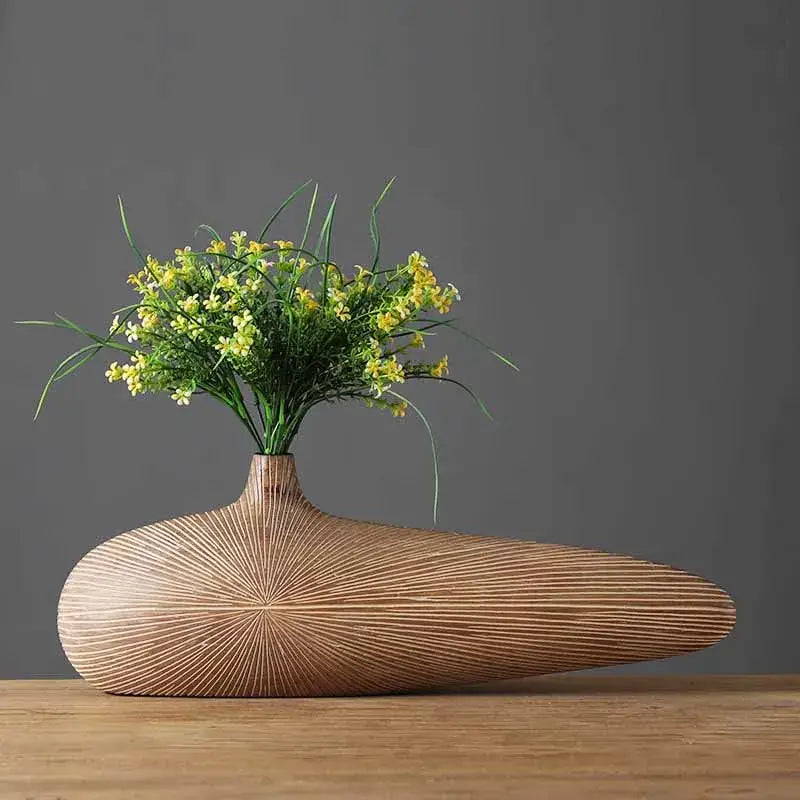 DecorBites™ contemporary resin vase in light brown with linear grooves holds vibrant yellow flowers