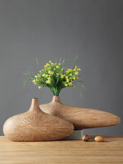 Two sleek light-brown wooden vases with radial grooves showcasing decorbites contemporary resin vase design