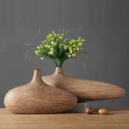Two light brown resin vases with radial grooves and teardrop shapes by decorbites contemporary resin vase