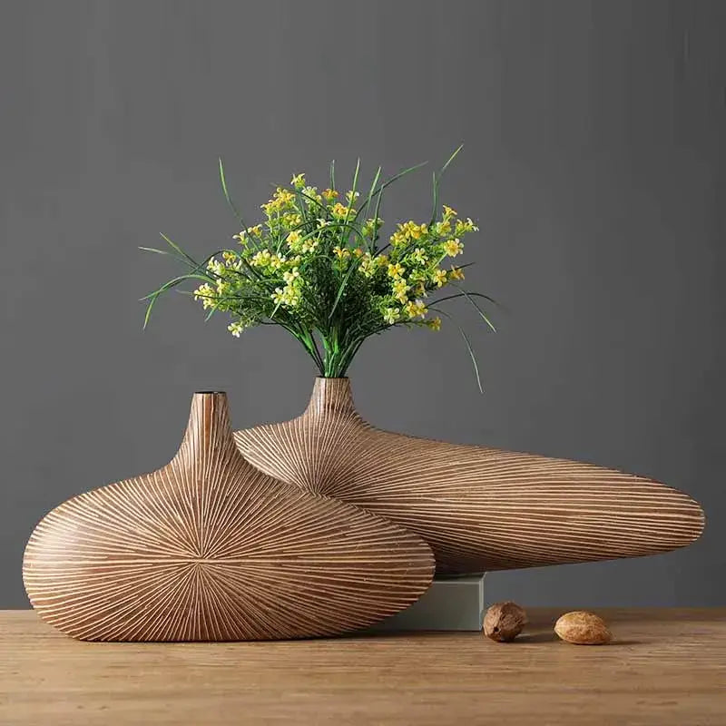 Two light brown resin vases with radial grooves and teardrop shapes by decorbites contemporary resin vase