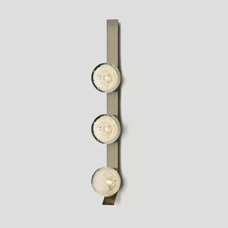 Decorbites™ contemporary wall light featuring three frosted glass globes on a brushed metal vertical bar fixture