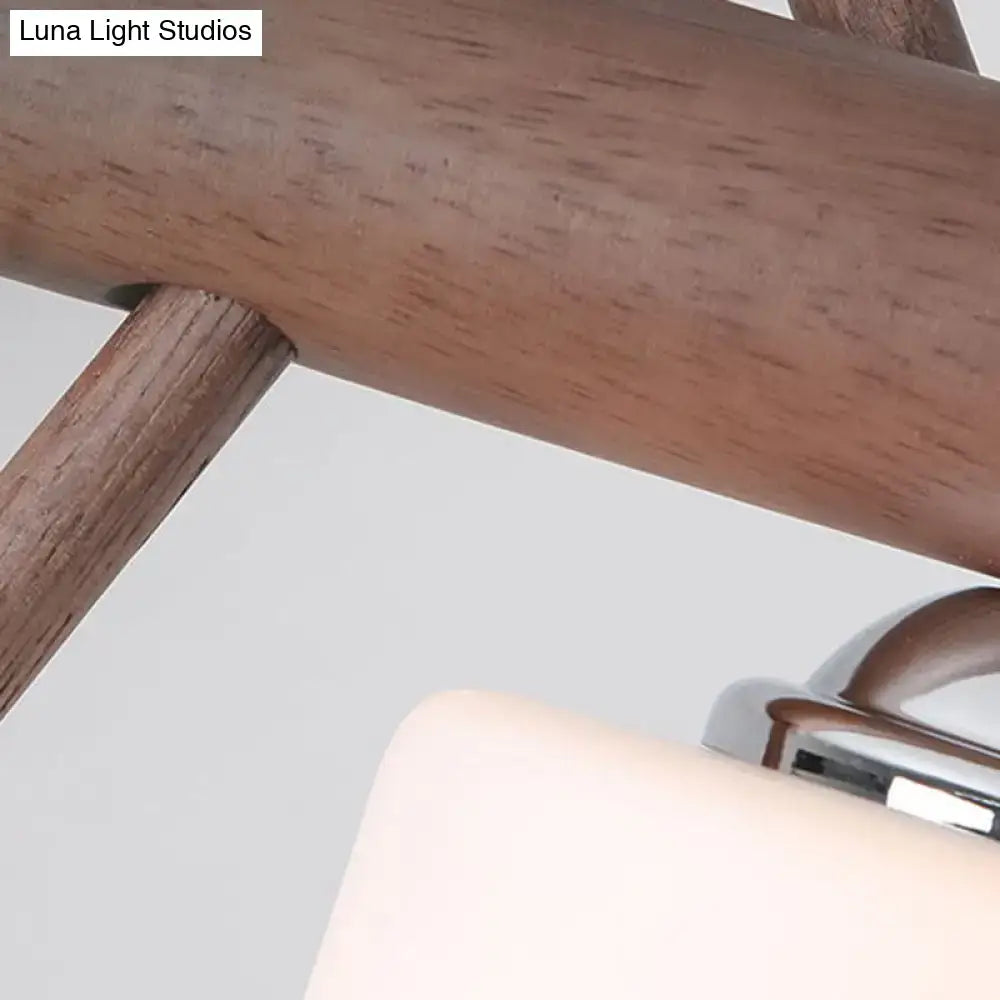A minimalist wooden chair with warm brown finish paired with decorbites cylindrical glass pendant lights e26 e27 bulbs