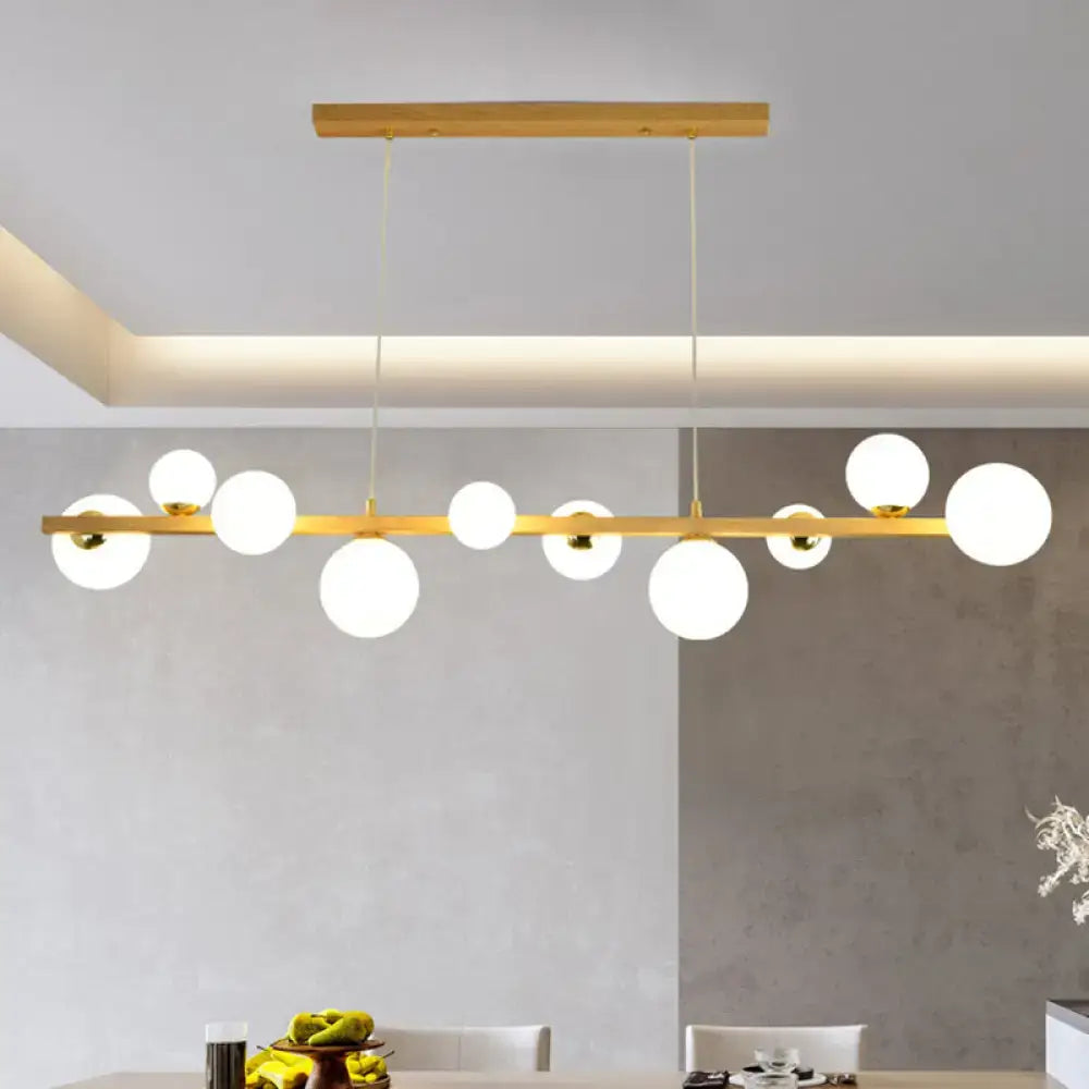 Modern gold-toned DecorBites™ wood pendant light with white glass globe shade for dining room 110v-120v