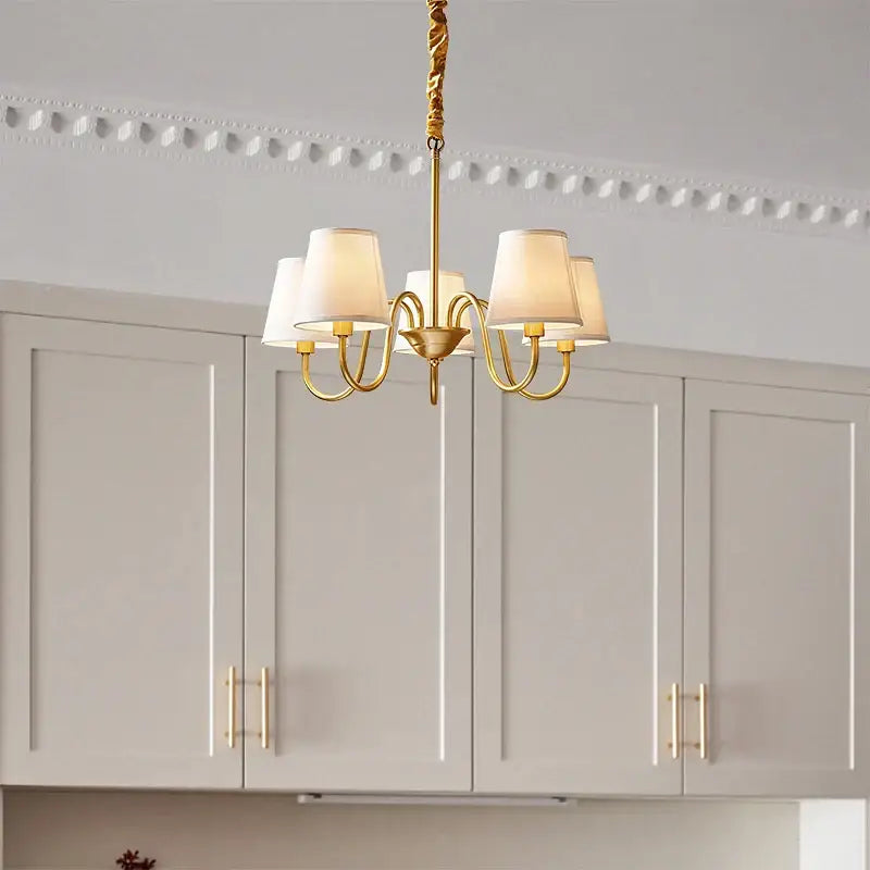 Gold-toned decorbites copper american chandelier with five cream fabric shades and twisted metal arms for living room