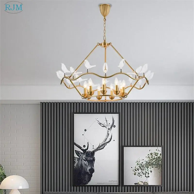 Gold-toned decorbites copper bird chandelier with delicate white glass bird ornaments and candle-style bulbs for dining room lighting