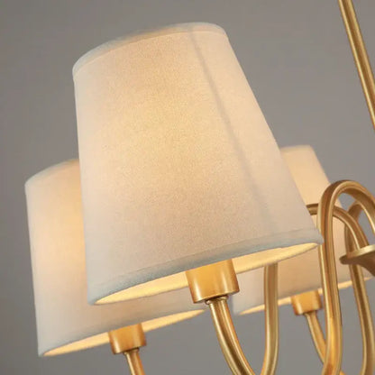 Cream-colored fabric lampshade with textured finish on polished brass arms in decorbites copper ceiling chandelier