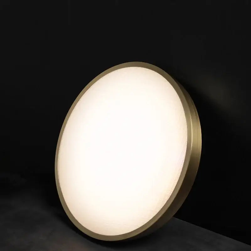 Modern brushed brass copper ceiling lamp with frosted glass and warm diffused glow for bedroom lighting