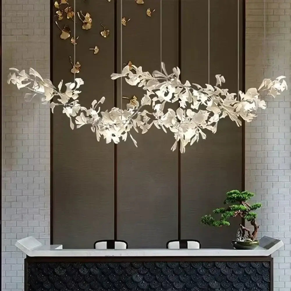 Elegant white ginkgo leaf chandelier lantern with sculpted branches suspended for luxury dining room lighting
