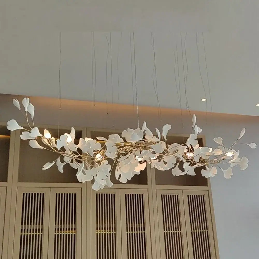 Elegant white ginkgo leaf chandelier lantern with delicate metallic branches and warm glowing lights for dining room luxury