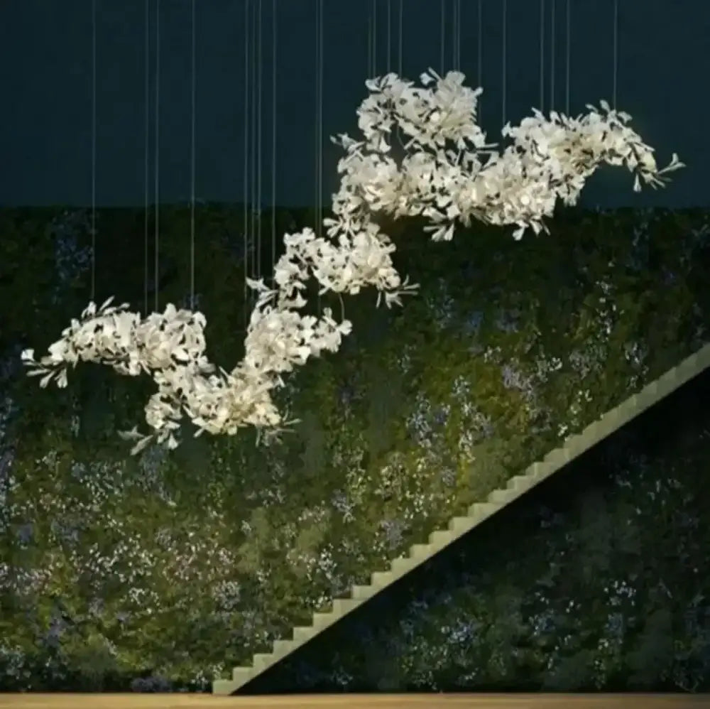 White ginkgo leaf chandelier lantern in elegant white floral design suspended against dark green moss wall for dining room luxury light