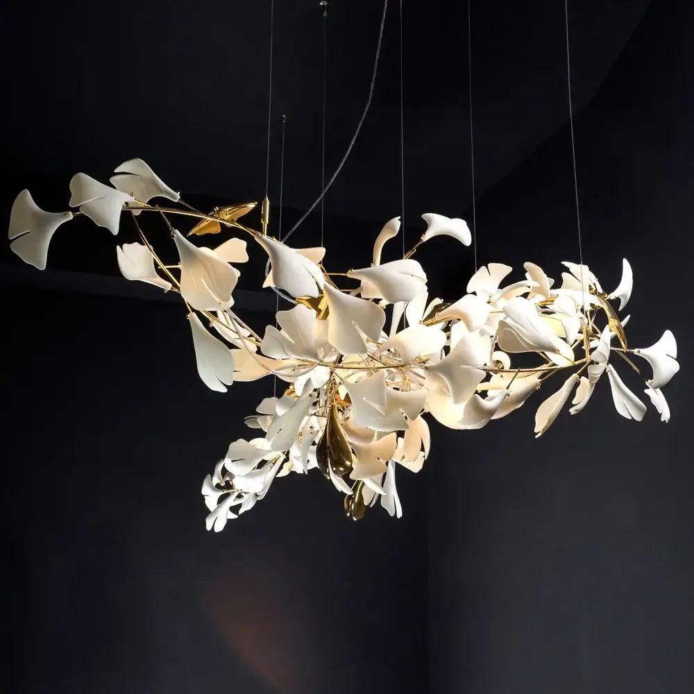 Elegant white ginkgo leaf chandelier lantern with gold-toned metallic stems for luxury dining room lighting