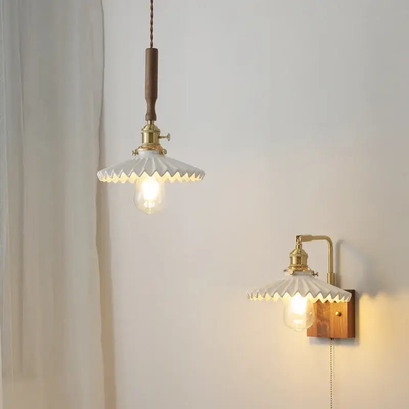 White ceramic led pendant light and wall sconce with brass accents and wooden fixtures for kitchen use