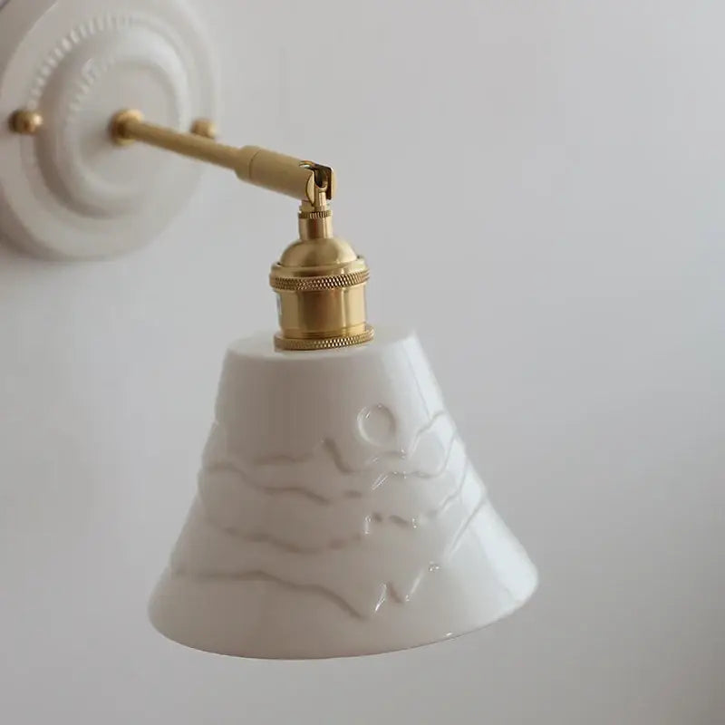 White and gold copper ceramic led wall lamp with brass hardware and embossed wave patterns for living room use