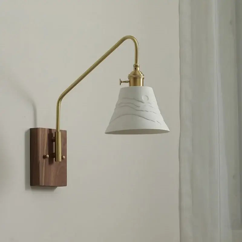 Modern brass and copper ceramic led wall lamp with white wave embossed ceramic shade on dark wood base for bedroom
