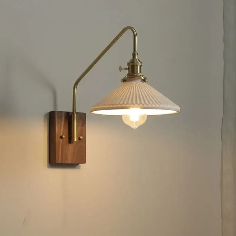 Modern brass and copper ceramic led wall lamp with vintage brass arm wooden backplate and off-white ribbed glass shade for bedroom