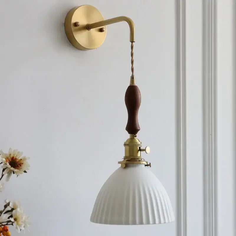 Vintage brass and dark wood led wall lamps with a white ribbed glass shade and ceramic led wall sconce for bedroom use