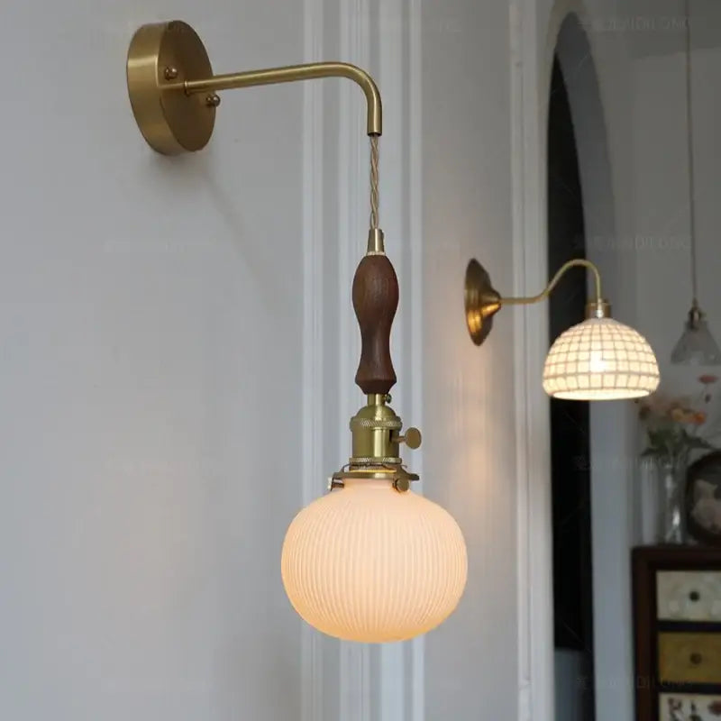 Antique brass wall lamp with dark wood handle and ribbed opal glass globe perfect as vintage led wall lamps