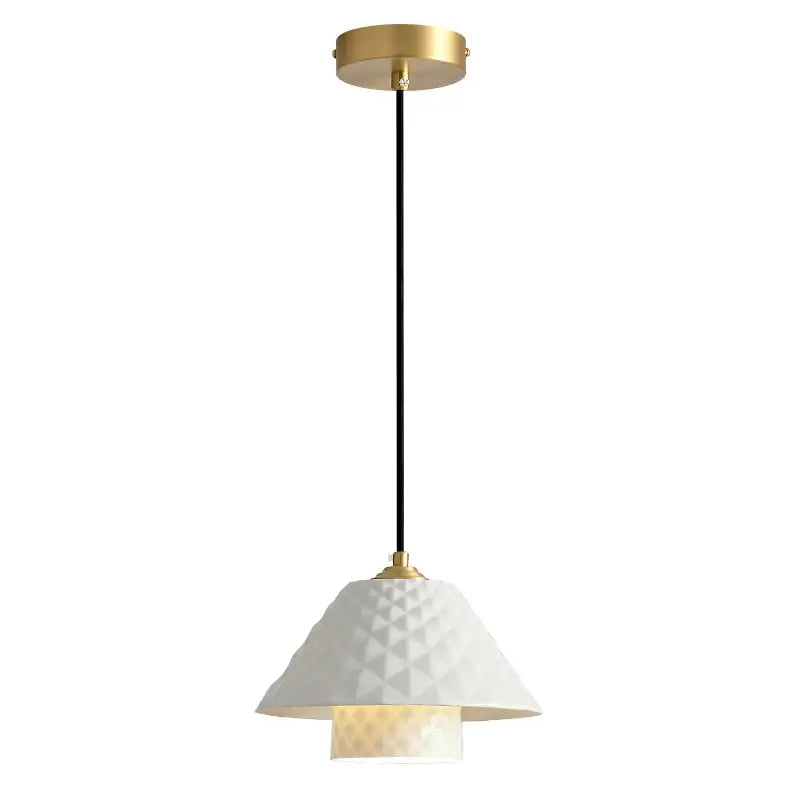 A modern white ceramic pendant light with a geometric glass shade and gold hardware for kitchen or dining room
