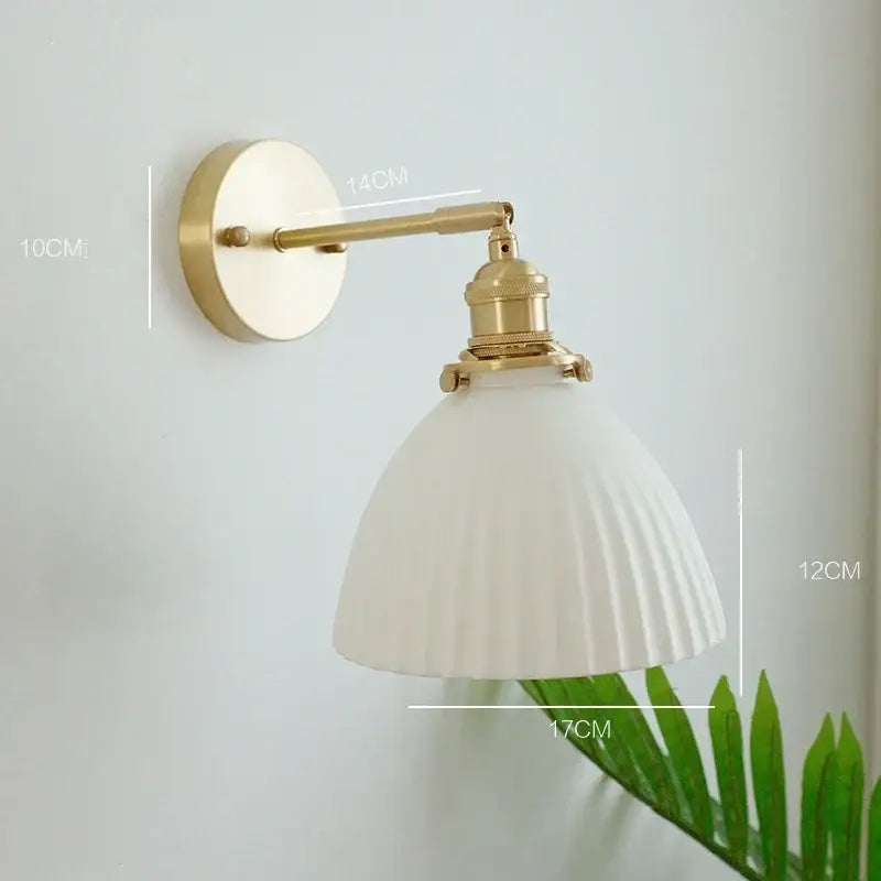 Vintage brass and ceramic led wall sconce with off-white ribbed glass shade and brass-finished metal arm for bedroom wall light