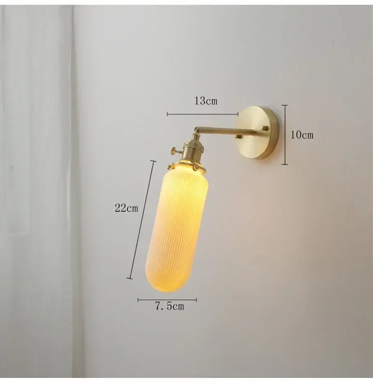 Vintage brass and ceramic led wall sconce with warm yellow ribbed glass lamp and brass-finished metal arm wall light