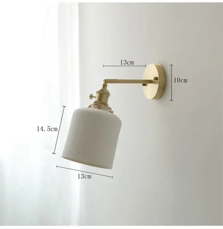 Vintage brass and ceramic led wall sconce with off-white ribbed ceramic shade and brass arm wall light for bedroom use