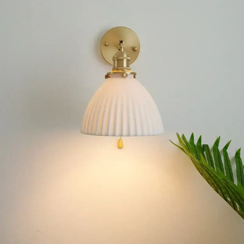 White ribbed glass wall sconce with brass finish and pull chain for vintage led wall light bedroom use