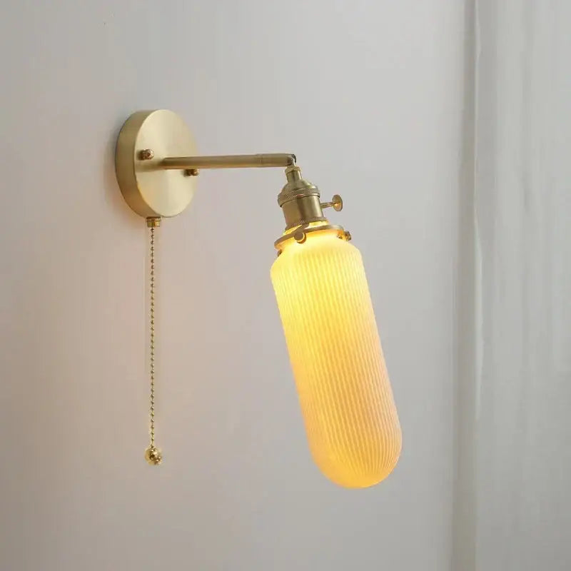 Vintage brass and ceramic led wall sconce with ribbed amber glass shade and adjustable chain pull wall light for bedroom
