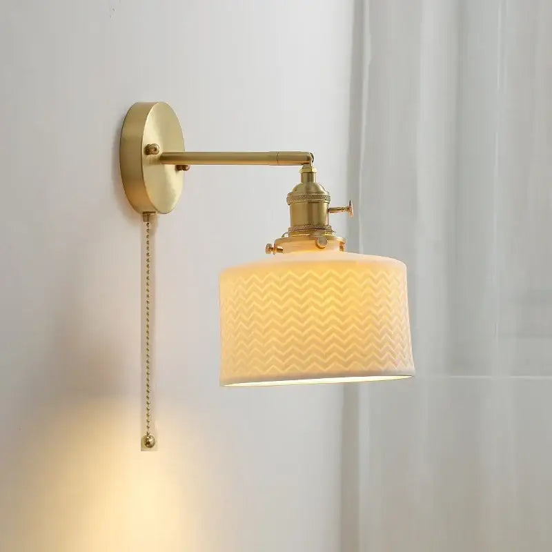 Vintage brass and ceramic led wall sconce with cream fabric chevron shade and pull chain for bedroom wall light use