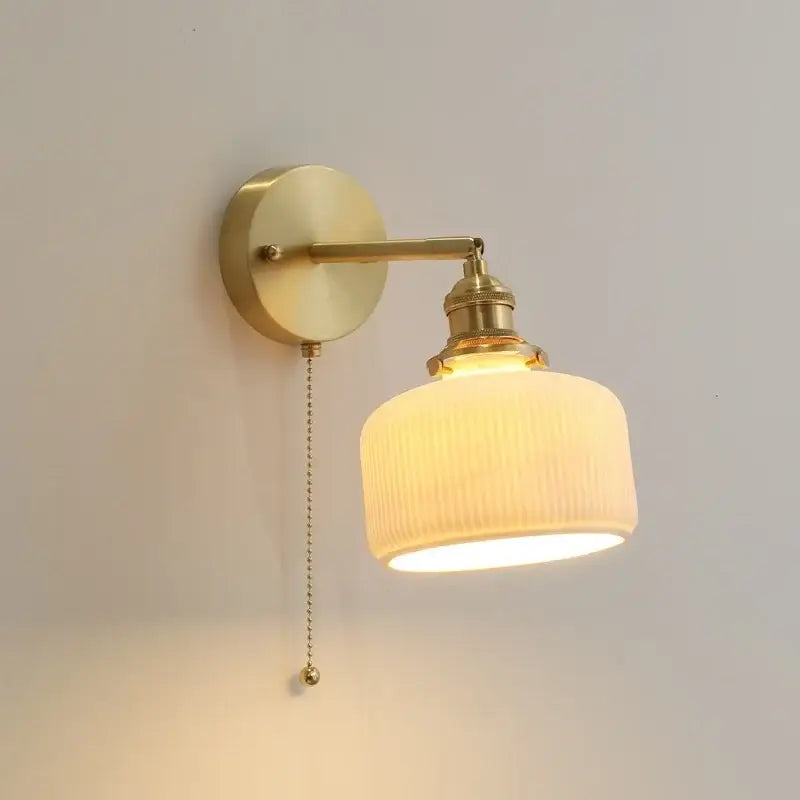 Vintage brass and ceramic led wall sconce with brass finish adjustable arm and ribbed off-white glass shade wall light