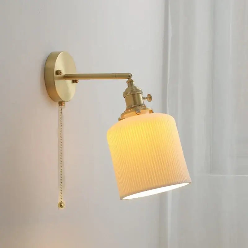 Vintage brass and ceramic led wall sconce with textured warm fabric shade and pull chain for bedroom wall light use