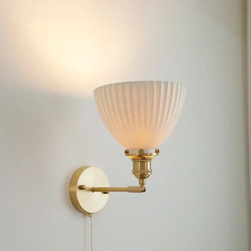 Vintage brass and ceramic led wall sconce featuring a warm-toned ribbed glass lampshade and adjustable pull chain wall light