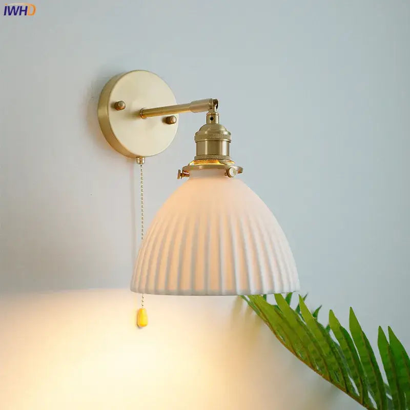 Vintage brass and ceramic led wall sconce with off-white ribbed shade for warm bedroom wall light with pull chain