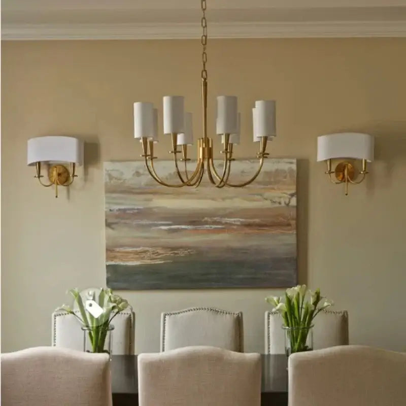 Elegant copper chandelier lights with six white fabric shades hang above the dining table decorbites copper chandelier