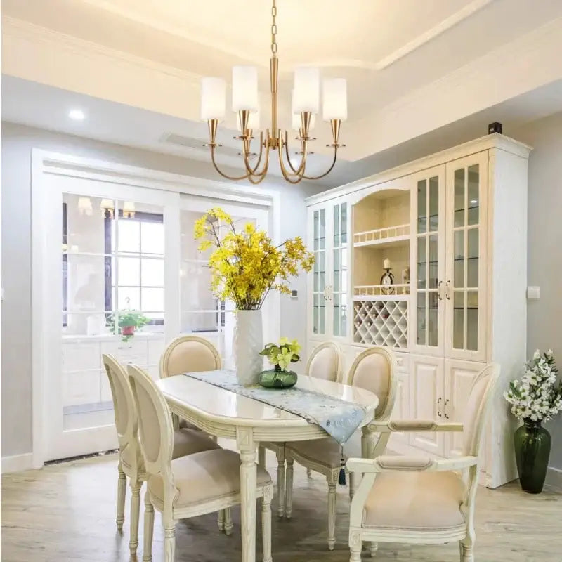 A cream-colored decorbites copper chandelier with six frosted fabric shades and gold-toned metal frame for living room decor