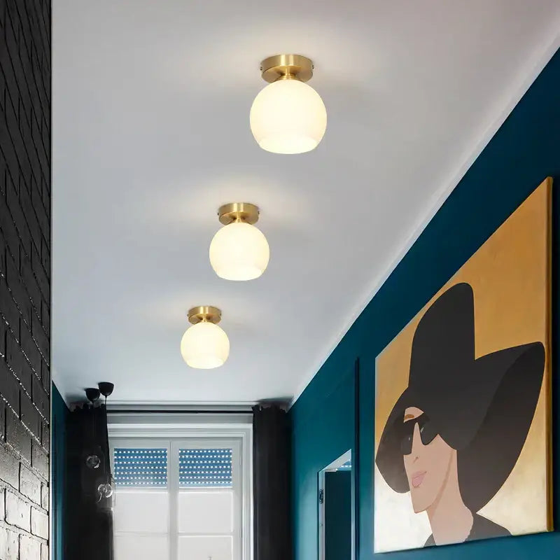 Modern decorbites copper chandelier with three frosted glass globe lights and brass fixtures for hallway ceiling use