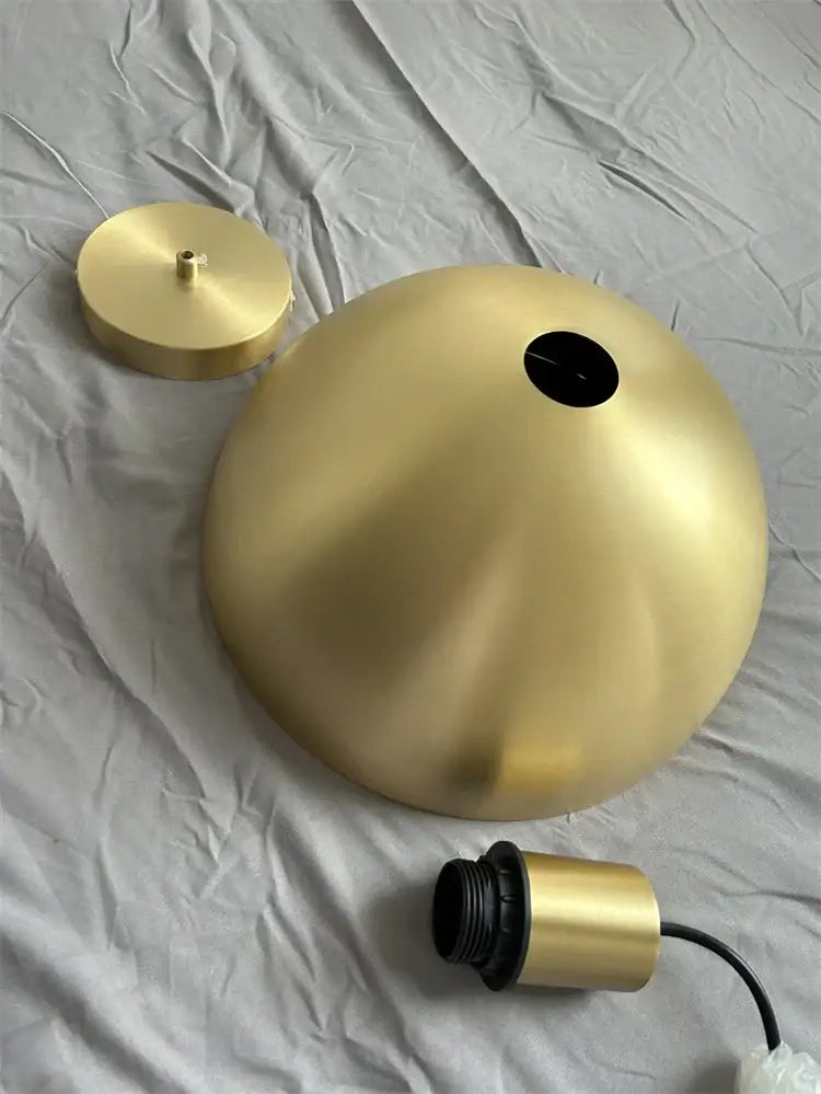 Gold-colored dome-shaped pendant light fixture with black-threaded holder in decorbites copper chandelier design