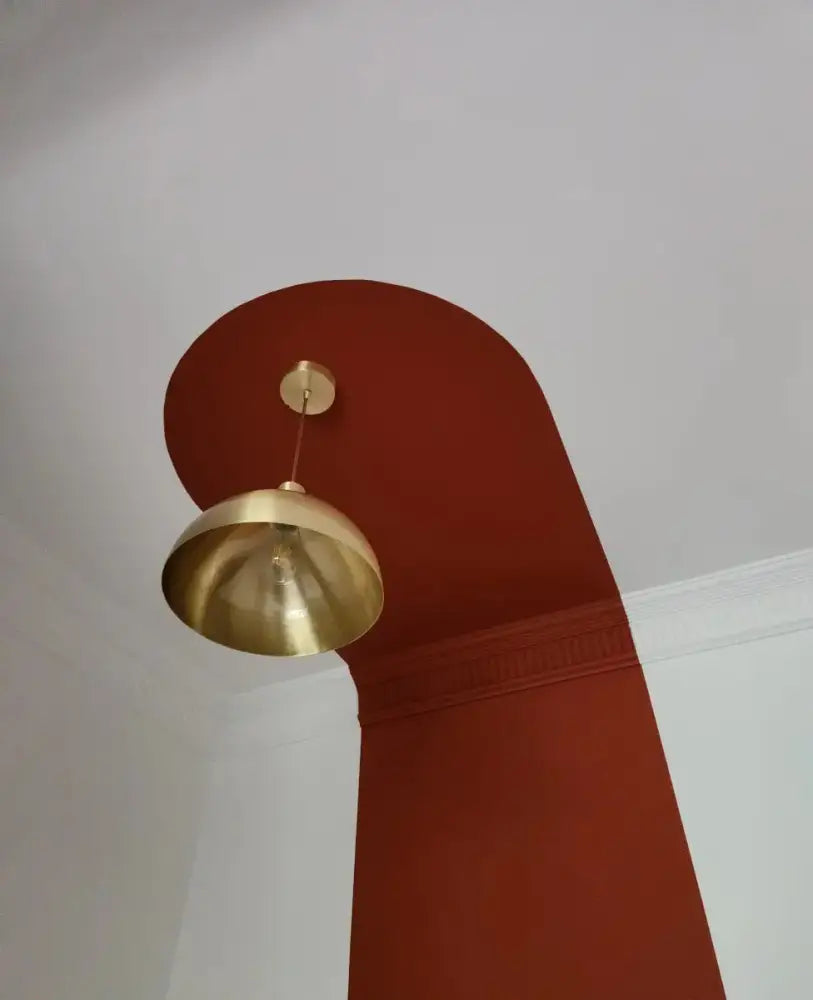 A sleek decorbites copper chandelier with a golden dome shape and polished brass finish kitchen pendant light
