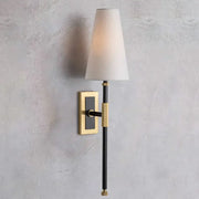 A sleek black and brass copper cloth led wall lamp with a tapered white fabric shade for bedroom reading