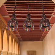 Three dark metal art deco copper cluster pendant ceiling lights with colorful glass beads and tassels for corridors
