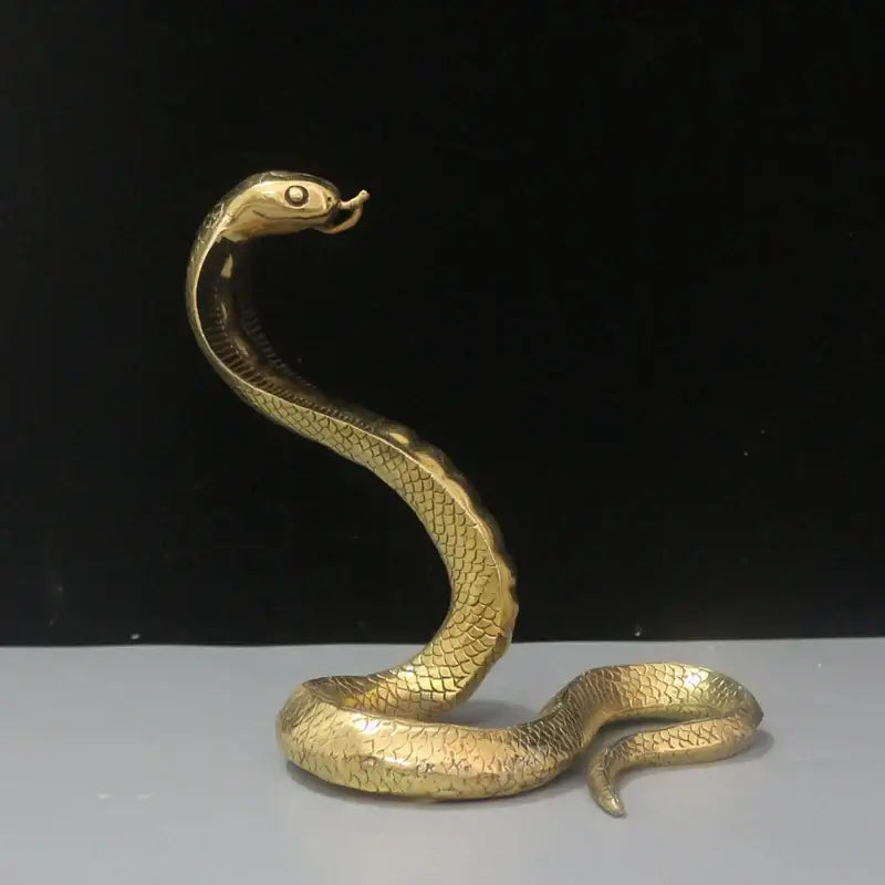 Golden brass cobra zodiac snake figurine with detailed scales and raised hood for living room decor