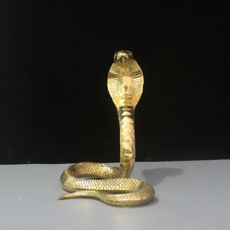 Golden brass cobra zodiac snake statue with detailed scales and raised hood for living room decor