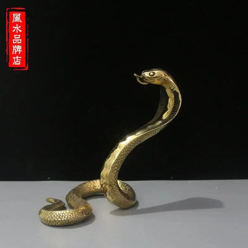 Golden brass cobra zodiac snake statue with detailed scales and raised hood for living room decor