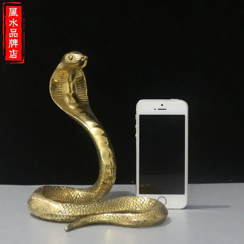 Golden brass cobra zodiac snake statue with detailed scales and raised hood for living room decor in metallic finish
