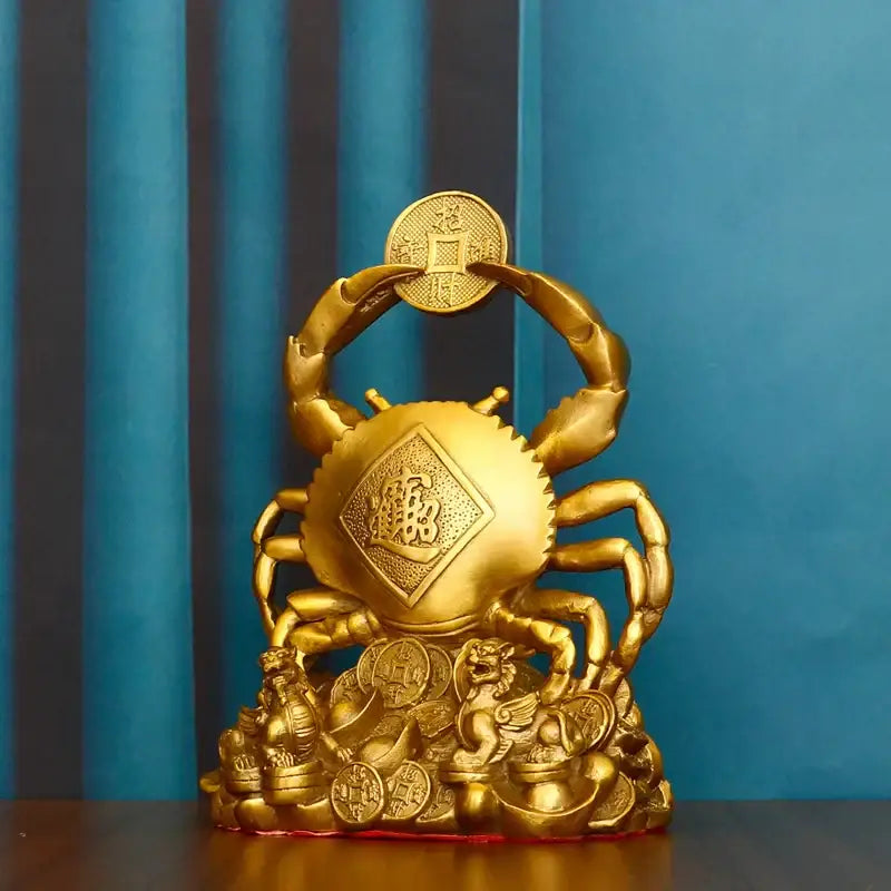 Golden metallic copper crab ornament with intricate carvings holding a coin surrounded by stacked coins for luxury decor