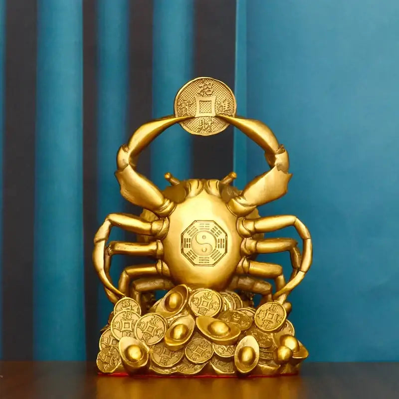 Golden copper crab ornament with intricate details holding a coin surrounded by gold coins for luxury decor