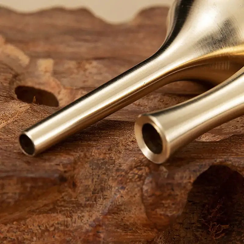 Two slender brass-colored pure copper tall vases with polished finish for elegant home decor on wooden surface